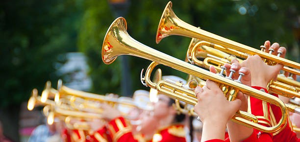 girl brass band in red uniform performing
